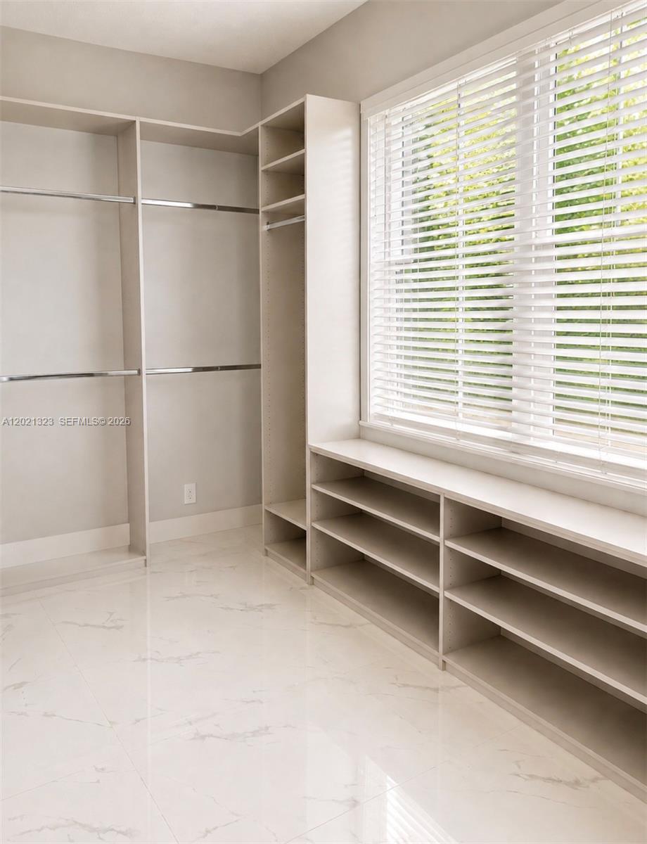 354 Mallard Road, Unit O Weston, FL 33327 - Photo 7 of 29 a view of an empty room with a window
