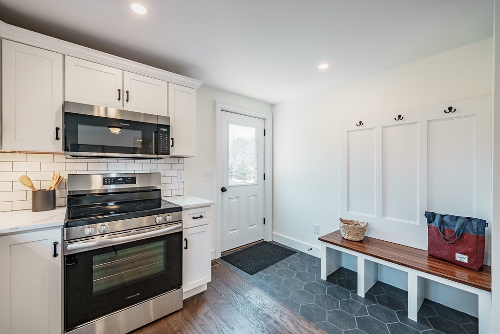 41 Leverett Road Amherst, MA 01002 - Photo 3 of 27 a kitchen with granite countertop a stove a sink and a microwave