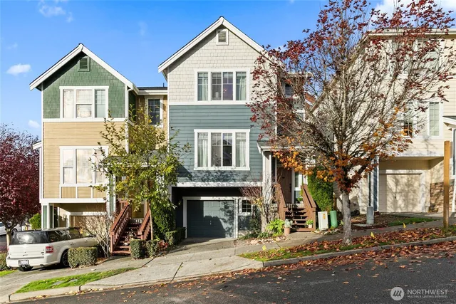 a front view of a house with a tree