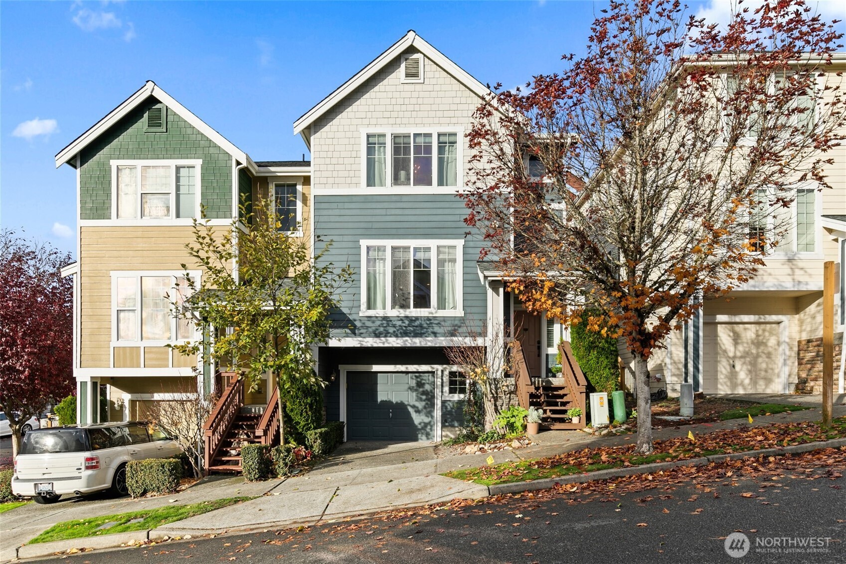 a front view of a house with a tree