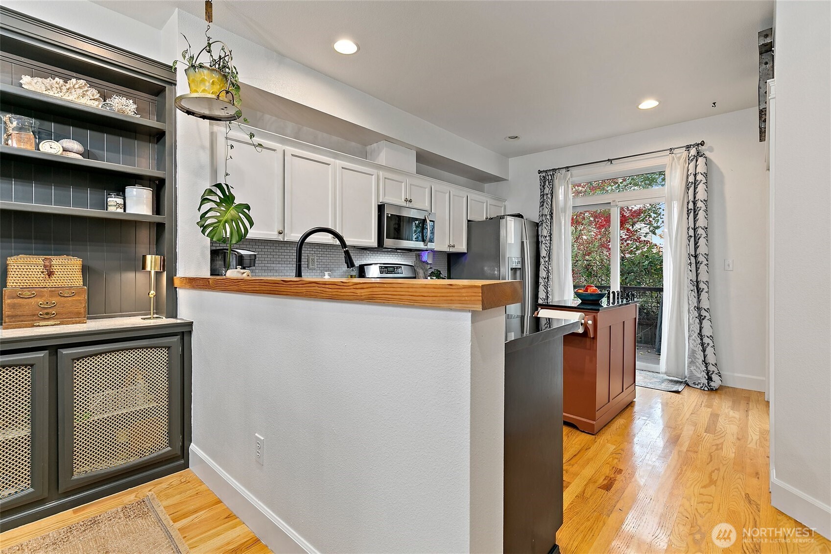 137 Maple Street Tacoma, WA 98466 - Photo 11 of 39 a kitchen with kitchen island a counter top space a sink stainless steel appliances and cabinets