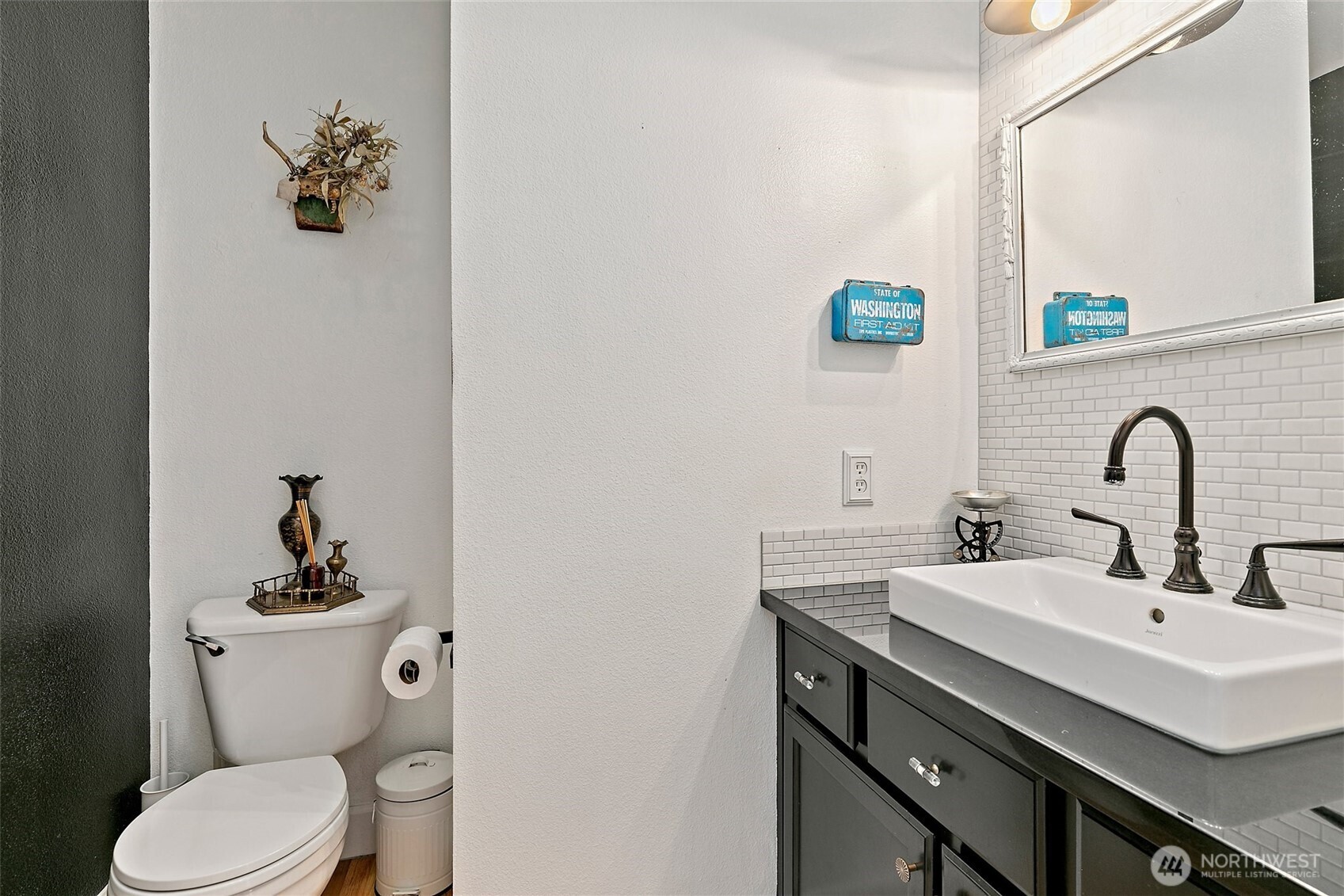 137 Maple Street Tacoma, WA 98466 - Photo 17 of 39 a bathroom with a sink a toilet and mirror