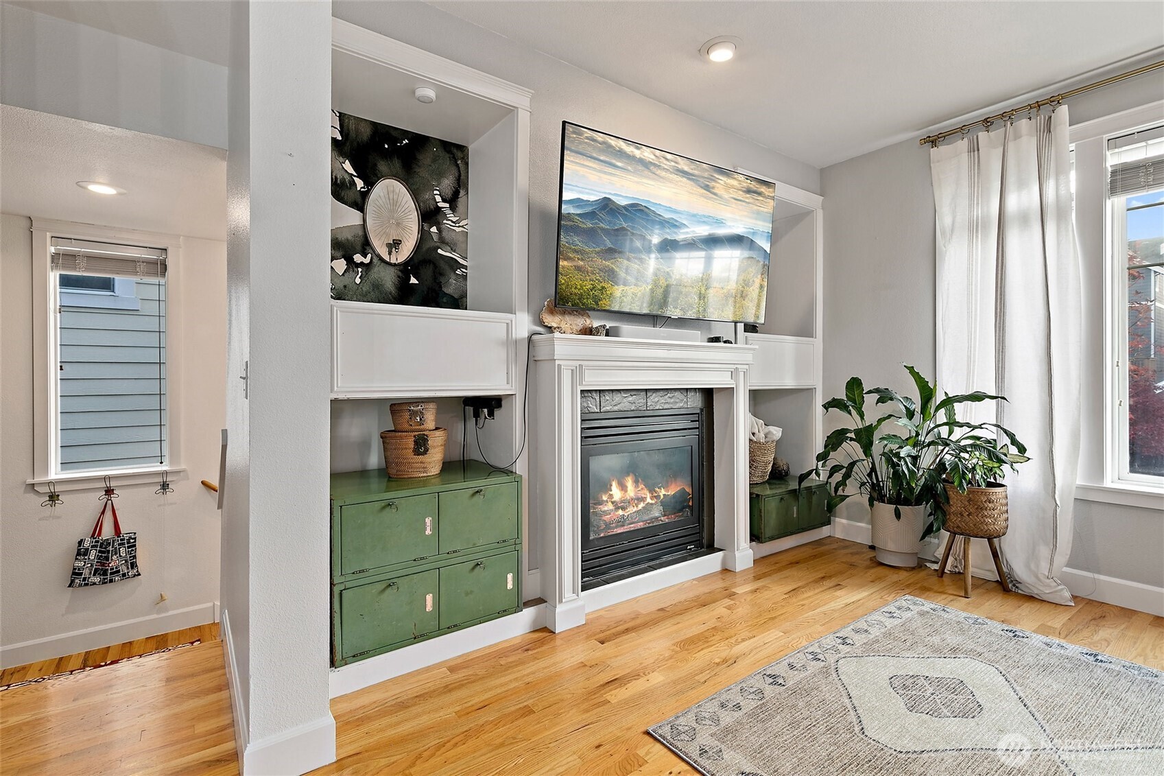 137 Maple Street Tacoma, WA 98466 - Photo 4 of 39 a living room with a fireplace and a flat screen tv