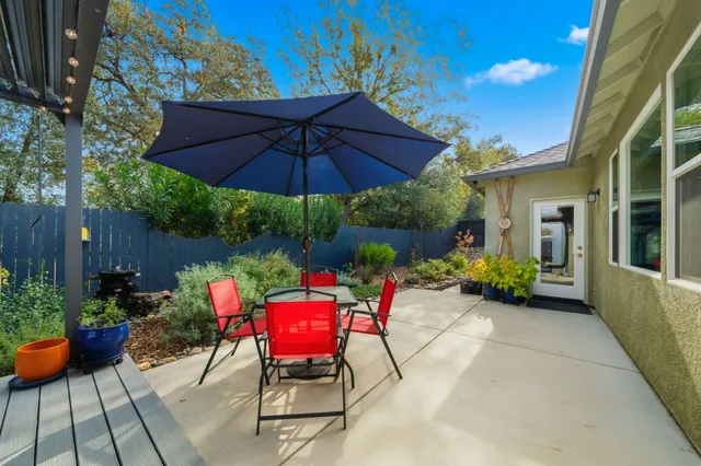 a view of a chairs and table in the patio with a fire pit
