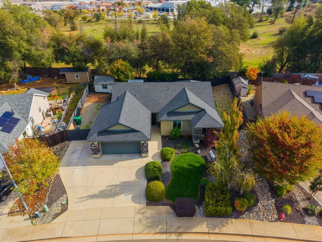 an aerial view of a houses with yard
