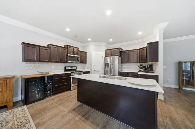 a large kitchen with stainless steel appliances and a sink