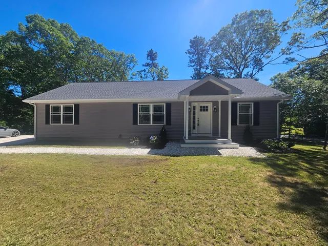 a front view of a house with a garden