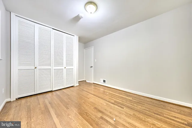 an empty room with wooden floor