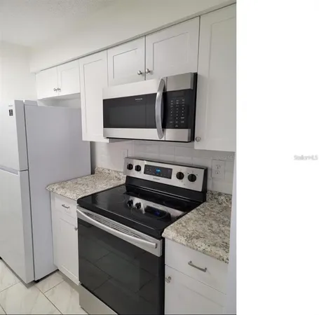 a kitchen with a stove and a microwave