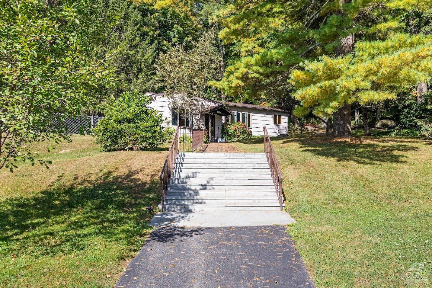 7951 Highway 22 Copake Falls, NY 12517 - Photo 17 of 40 a view of a yard with plants and large trees