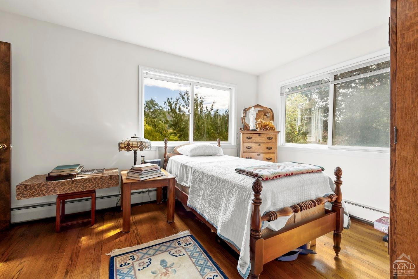 7951 Highway 22 Copake Falls, NY 12517 - Photo 23 of 40 a bed sitting in a bedroom next to a window