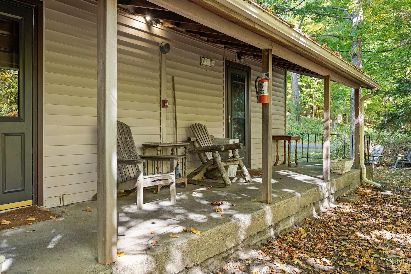 7951 Highway 22 Copake Falls, NY 12517 - Photo 28 of 40 a view of a patio with table and chairs and floor to ceiling window
