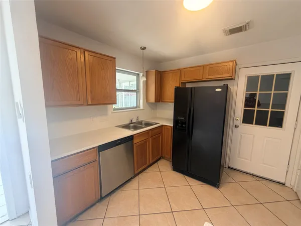 a kitchen with a refrigerator and window