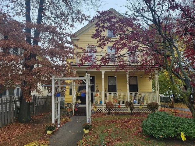 a view of a house with a chairs and table in a patio