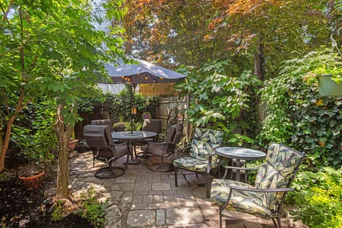 a backyard of a house with table and chairs