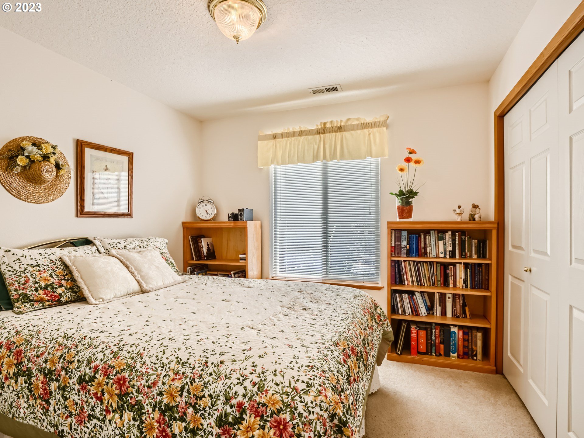1167 Southeast Eagle Lane Gresham, OR 97080 - Photo 17 of 25 a bedroom with a bed and a book shelf