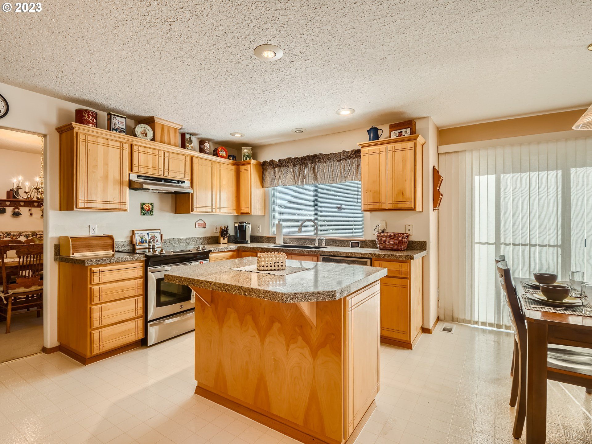 1167 Southeast Eagle Lane Gresham, OR 97080 - Photo 4 of 25 a kitchen with stainless steel appliances granite countertop a stove a sink a microwave and a refrigerator