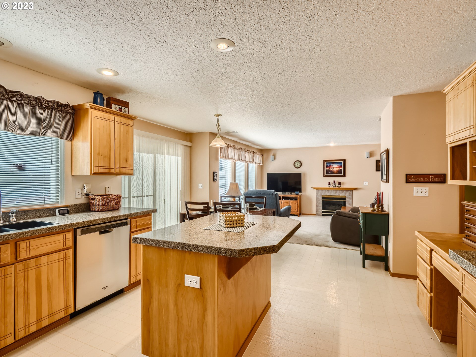 1167 Southeast Eagle Lane Gresham, OR 97080 - Photo 6 of 25 a large kitchen with lot of cabinets and wooden floor