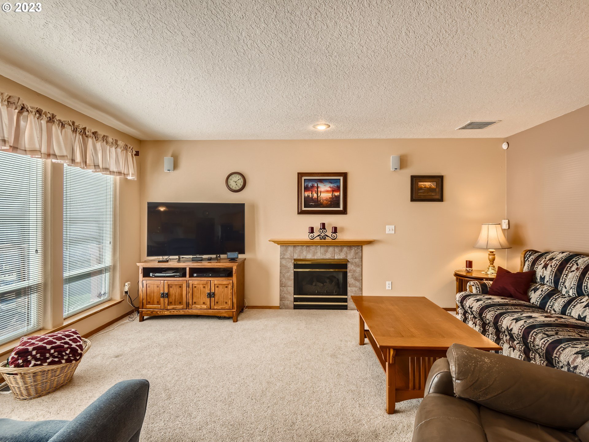 1167 Southeast Eagle Lane Gresham, OR 97080 - Photo 8 of 25 a living room with furniture and a flat screen tv