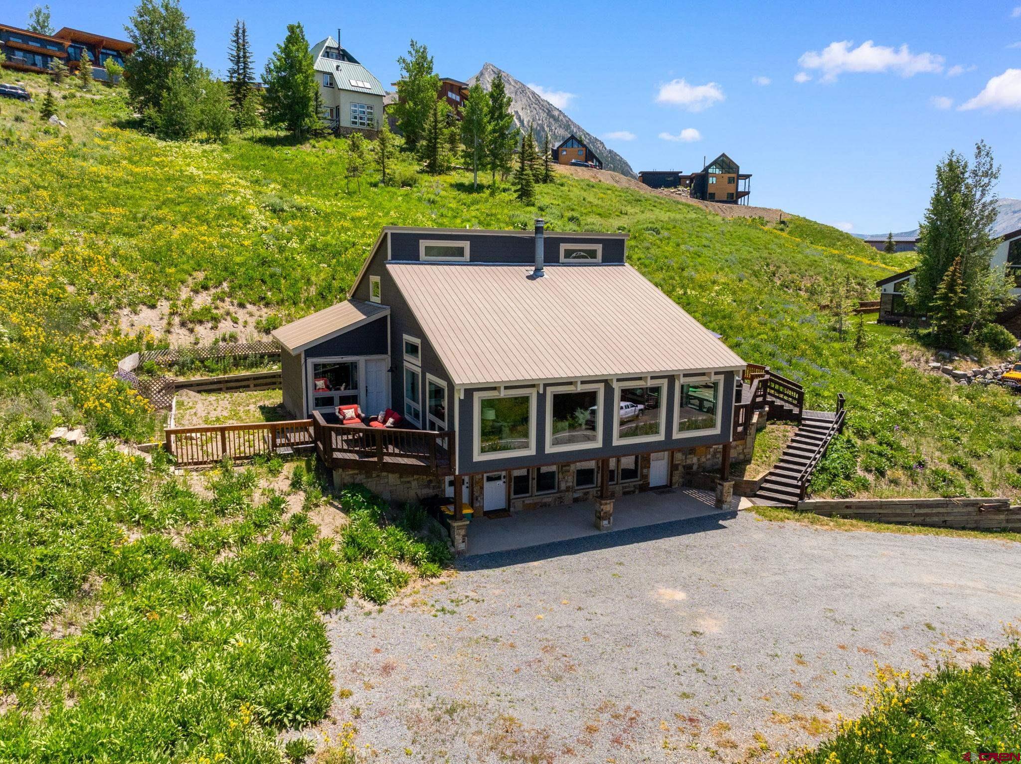 an aerial view of a house with garden space and street view