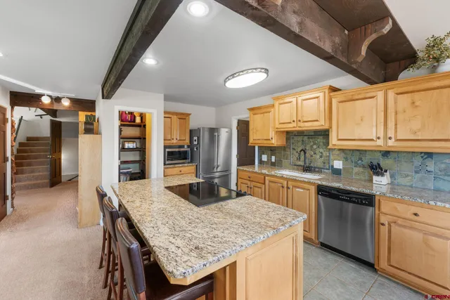 a kitchen with stainless steel appliances granite countertop a sink and cabinets