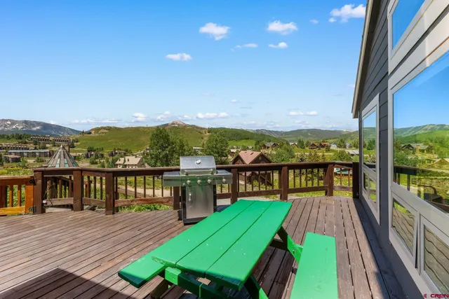 a view of a balcony with wooden floor and city view