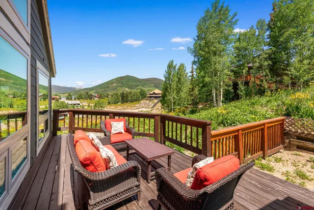 a balcony with wooden floor and furniture