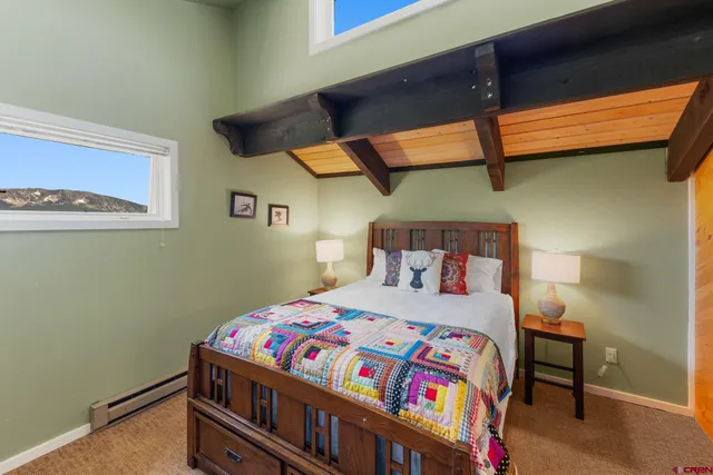 a bedroom with a bed a baby desk and chair