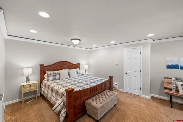 a bedroom with a bed and a lamp