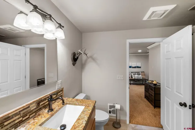 a bathroom with a sink a light fixture and a mirror