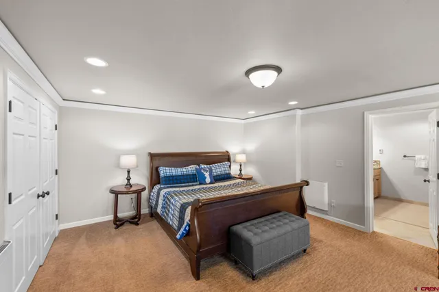 a bedroom with a bed and a lamp