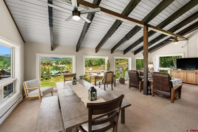 a living room with patio furniture and a flat screen tv