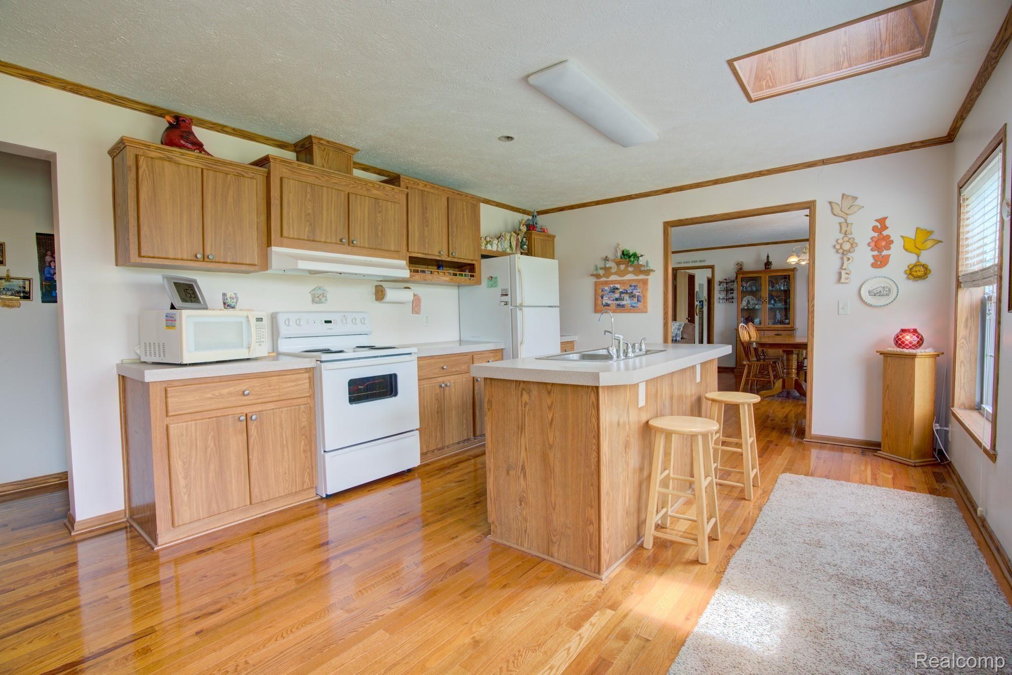 12145 South Bancroft Road Morrice, MI 48857 - Photo 10 of 41 VIEW INTO LIVING ROOM AND DINING AREA OR USE FOR LARGER LIVING ROOM AREA