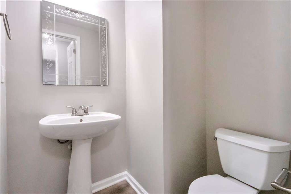 344 Springbottom Court Southeast Lawrenceville, GA 30046 - Photo 12 of 26 a bathroom with a toilet sink and mirror