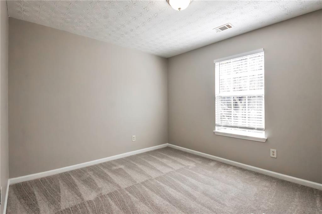 344 Springbottom Court Southeast Lawrenceville, GA 30046 - Photo 16 of 26 an empty room with a window