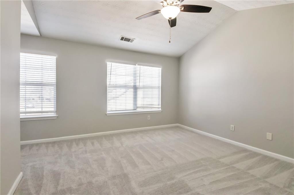 344 Springbottom Court Southeast Lawrenceville, GA 30046 - Photo 19 of 26 an empty room with a window and a fan