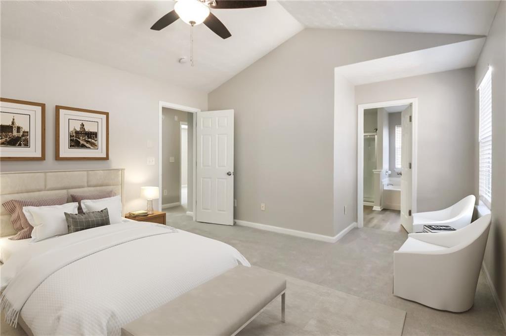 344 Springbottom Court Southeast Lawrenceville, GA 30046 - Photo 20 of 26 a spacious bedroom with a bed and a chandelier