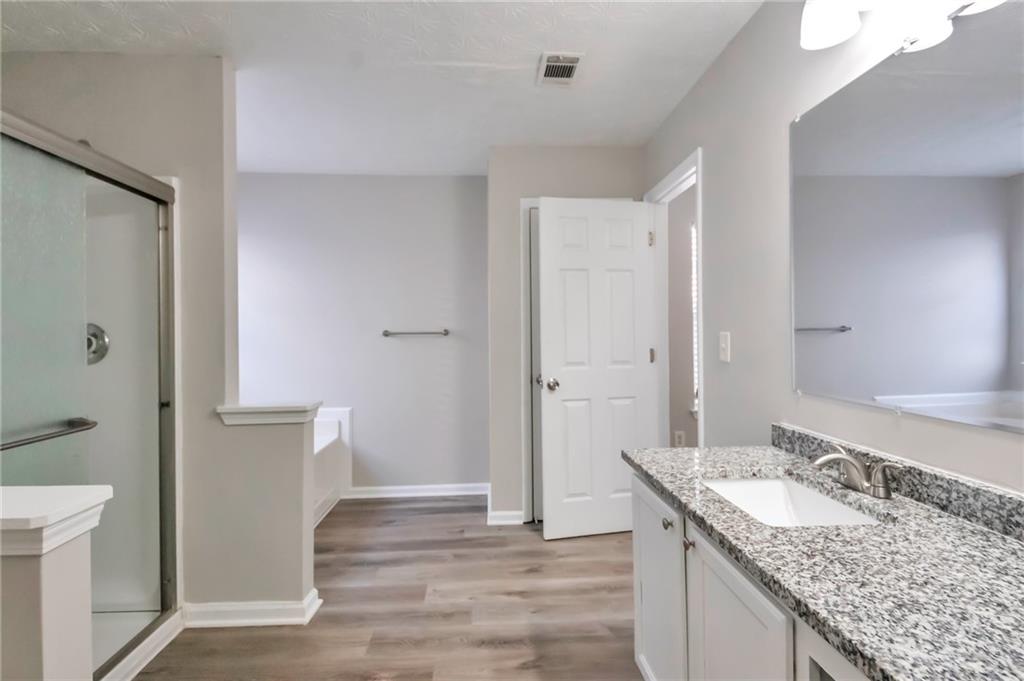 344 Springbottom Court Southeast Lawrenceville, GA 30046 - Photo 22 of 26 a bathroom with a granite countertop sink and a mirror