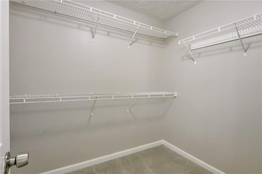 344 Springbottom Court Southeast Lawrenceville, GA 30046 - Photo 24 of 26 a view of a room with racks on the wall