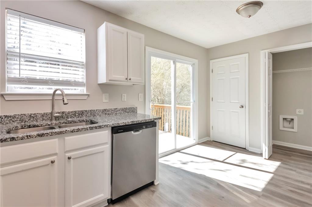 344 Springbottom Court Southeast Lawrenceville, GA 30046 - Photo 10 of 26 a kitchen with granite countertop a sink cabinets and window
