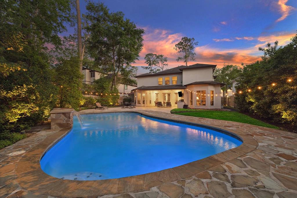 The sound of a waterfall and the glow of landscape lighting create attractive relaxation. The large pool is surrounded by a flagstone deck with plenty of room for sunnng and entertaining. Conveniences include french drains to assist with Texas rainstorm run-off and automatic sprinklers to help keep everything green.