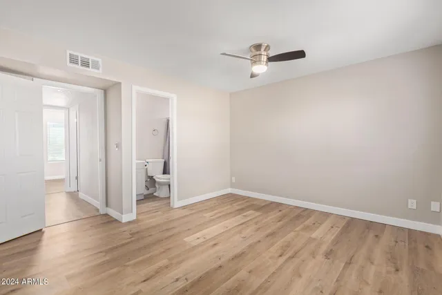 an empty room with wooden floor