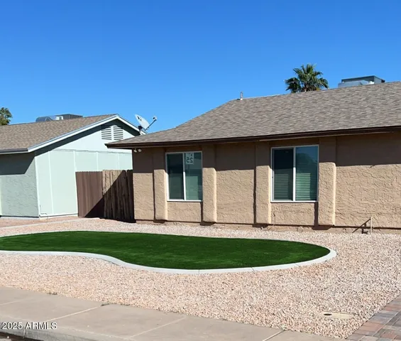 a view of empty room with wooden floor and a ceiling fan