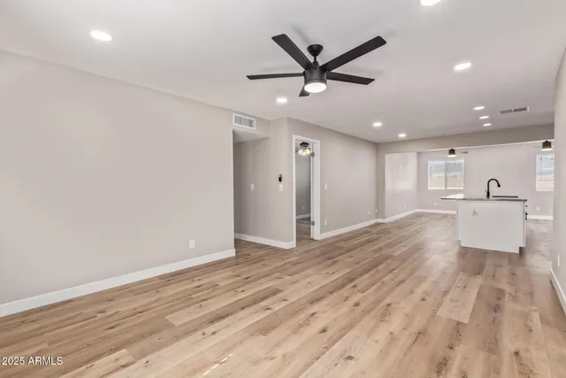 a view of kitchen with kitchen island wooden floor center island and appliances