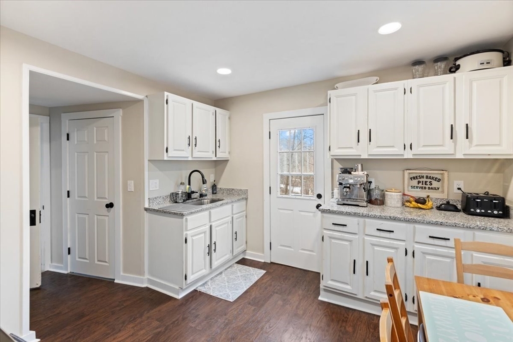64 Parker Street Maynard, MA 01754 - Photo 11 of 39 a kitchen with stainless steel appliances granite countertop a stove and cabinets