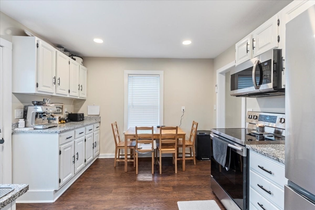 64 Parker Street Maynard, MA 01754 - Photo 12 of 39 a kitchen with stainless steel appliances granite countertop a stove top oven a sink dishwasher and white cabinets