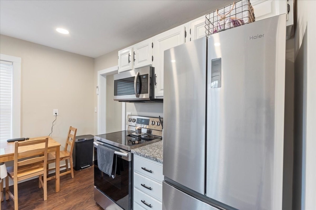 64 Parker Street Maynard, MA 01754 - Photo 13 of 39 a kitchen with a refrigerator stove and microwave