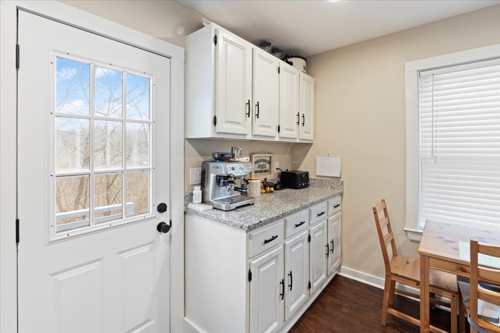 64 Parker Street Maynard, MA 01754 - Photo 14 of 39 a kitchen with white cabinets and window