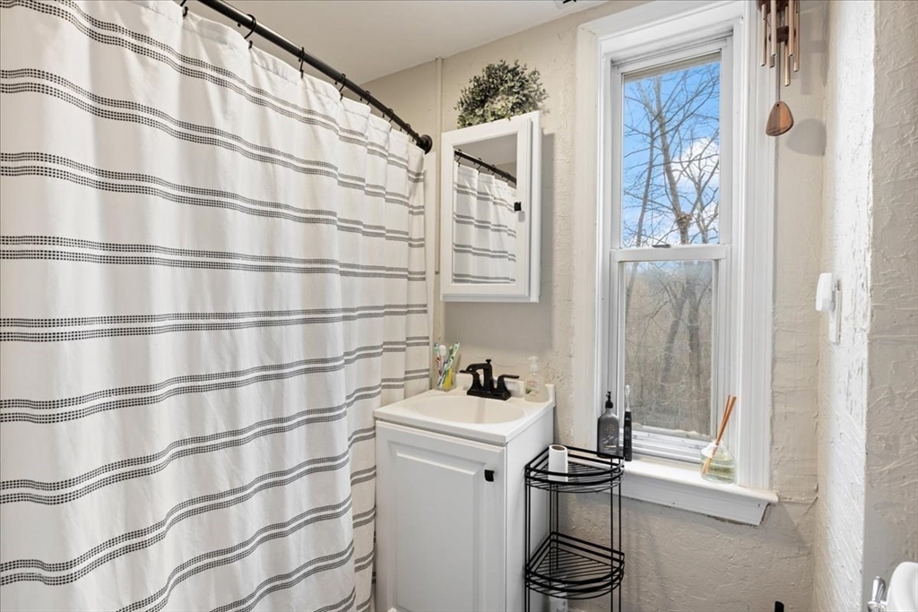 64 Parker Street Maynard, MA 01754 - Photo 18 of 39 a bathroom with a sink and a mirror