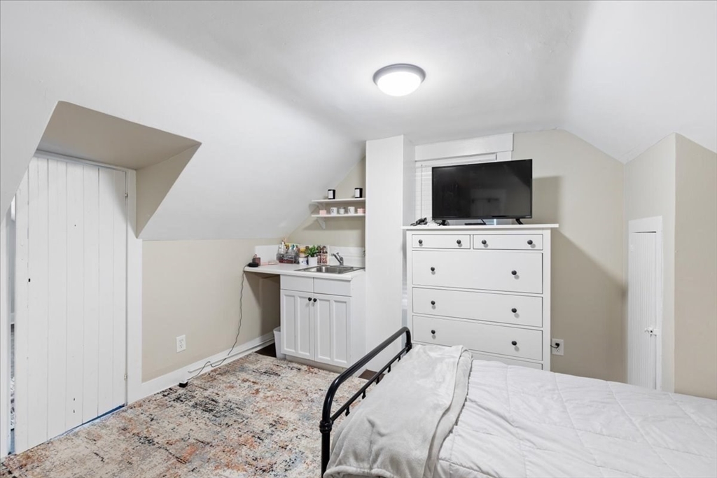 64 Parker Street Maynard, MA 01754 - Photo 21 of 39 a bedroom with a bed and flat screen tv